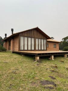 a house that is sitting on top of a field at Refúgio Rota das Nuvens in Bom Jardim da Serra