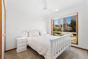 Ένα ή περισσότερα κρεβάτια σε δωμάτιο στο Breezy Bungalow at Malua