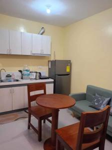 a kitchen with a table and a couch and a table and chairs at Zhabret's Place II in Lapu Lapu City