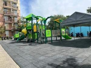a park with a playground with a slide at Zhabret's Place II in Lapu Lapu City