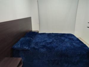 sypialnia z niebieską kołdrą na łóżku w obiekcie Corrientes Apart w mieście Corrientes