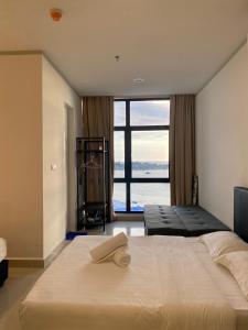 Un dormitorio con una cama grande con una ventana grande. en HS Homestay Shore Pasar Besar dan KK Plaza, en Kota Kinabalu
