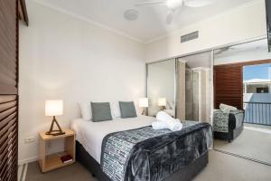 a bedroom with a large bed and a balcony at Rolling Surf Resort in Caloundra +65 photos