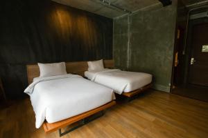 Postel nebo postele na pokoji v ubytování Navakitel Design Hotel