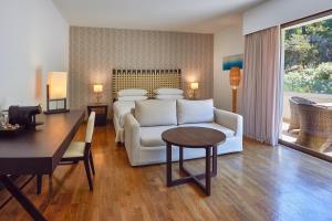 a living room with a white couch and a table at Sheraton Rhodes Resort in Ixia