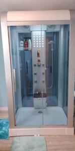 a shower with a glass door in a room at Coastal Cottage Bay House in Palacios