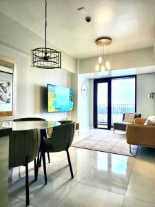 a living room with a dining table and a couch at Luxury 2 bedroom 2 bath Apartment near Bai Hotel in Mandaue City