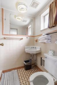 a bathroom with a toilet and a sink at DuBois Manor Motel in DuBois