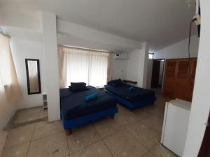 Postel nebo postele na pokoji v ubytování Hostal Tamara