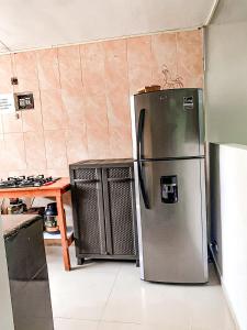a kitchen with a refrigerator and two trash cans at Apto cerca Estadio Metropolitano in Barranquilla +24 photos