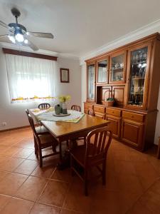 a dining room with a wooden table and chairs at Azores Treasure in Angra do Heroísmo