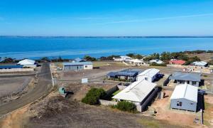 an aerial view of a farm with the water at Sand & Salt in Kingscote