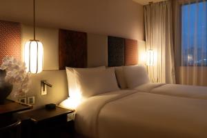 Postel nebo postele na pokoji v ubytování Suzu Saigon - A Boutique Hotel