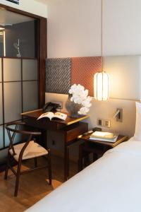 Postel nebo postele na pokoji v ubytování Suzu Saigon - A Boutique Hotel