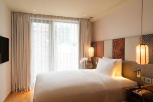 Postel nebo postele na pokoji v ubytování Suzu Saigon - A Boutique Hotel