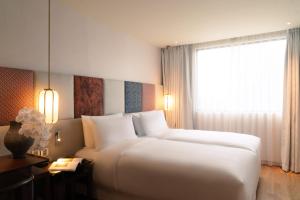 Postel nebo postele na pokoji v ubytování Suzu Saigon - A Boutique Hotel