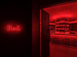 a red sign that says red in front of a bar at seven x seven ISHIGAKI in Ishigaki Island
