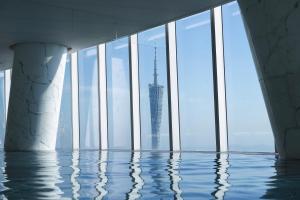 a view of the burj khalifa from a swimming pool in a building at Four Seasons Hotel Guangzhou in Guangzhou
