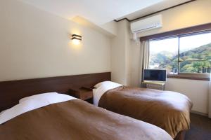 Postel nebo postele na pokoji v ubytování Ooedo Onsen Monogatari Toi Marine Hotel
