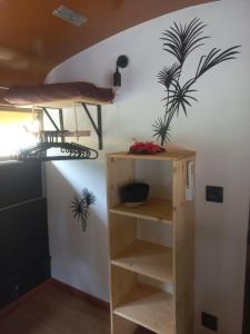 a room with a bunk bed and a shelf at Moe Bus House in Moorea