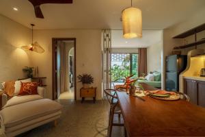 a kitchen and living room with a wooden table at Camfusion Hoi An in Hoi An +73 photos