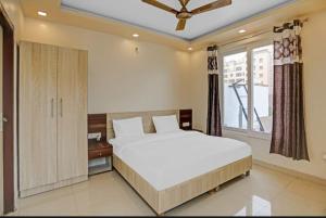 a bedroom with a large bed and a window at Expo View INN in Greater Noida