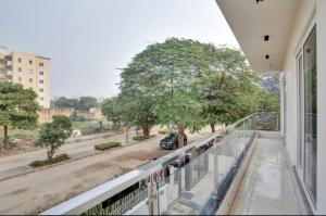 a balcony of a building with a view of a tree at Expo View INN in Greater Noida