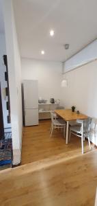 a dining room with a table and a refrigerator at Nocleg w Łodzi, Energetyków 1 in Łódź