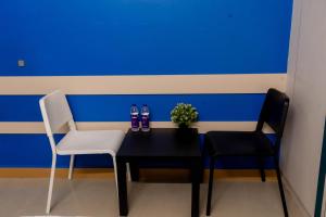 a table with two chairs and two bottles of soda at Sree Theja Residency in Anantapur