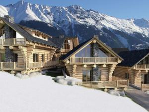 a log cabin in the snow with mountains in the background at Chalet in Ladis by Ski Slope & Sonnenbahn in Ladis