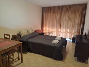 a bedroom with a bed and a table and a tableablish at Panorama Stoykite Belvedere in Stoykite