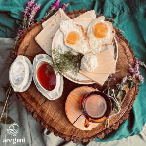 a plate of eggs and bread on a wooden tray at Eco Aura (rest zone / Sevan / Отдых) in Areguni +14 photos