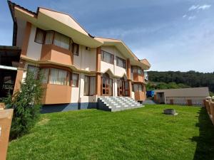 a house with a lawn in front of it at Winterfeel Bellmount by Neon Nest in Ooty
