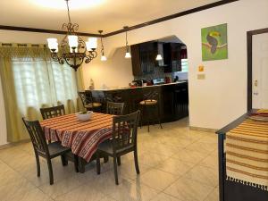a dining room and kitchen with a table and chairs at Casa Carimi, San Ignacio in San Ignacio +5 photos