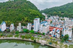 an aerial view of a city with buildings and a river at Chu Long Hotel & Spa in Cat Ba