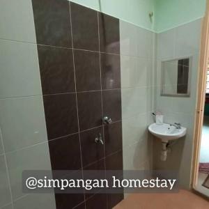 a bathroom with a shower and a sink at Simpangan Homestay Kuala Nerus in Kampong Gong Badak