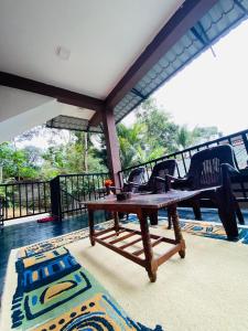 a wooden table and chairs on a patio at The Hobbit Cottage-Ella in Ella