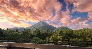 a view of a mountain under a cloudy sky at Ramana Towers in Tiruvannāmalai
