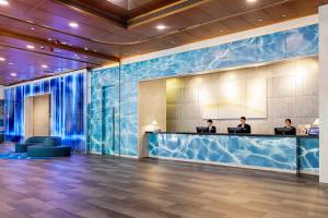 two people sitting at a reception desk in a lobby at Hotel COZi Harbour View in Hong Kong