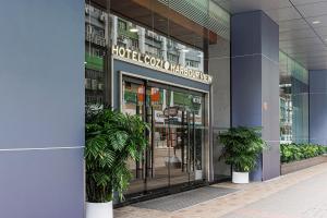 a store front with plants in front of a building at Hotel COZi Harbour View in Hong Kong