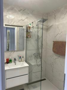 a white bathroom with a shower and a sink at Beautiful Villa near Medjugorje in Međugorje