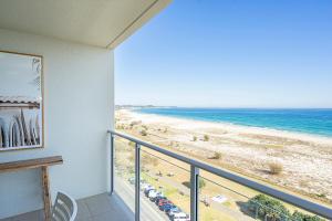a balcony with a view of the beach at Absolute Kirra by EcoTime in Gold Coast