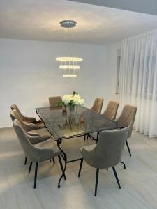 a dining room with a glass table and chairs at Beautiful Villa near Medjugorje in Međugorje +14 photos
