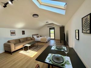 a living room with a couch and a table at Promo Studio Apartment in Pirot
