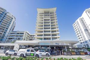 a parking lot with cars parked in front of a building at Absolute Kirra by EcoTime in Gold Coast
