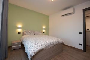 a bedroom with a bed and two lights on the wall at appartamenti Suly 1 cir0082 in Saint Vincent