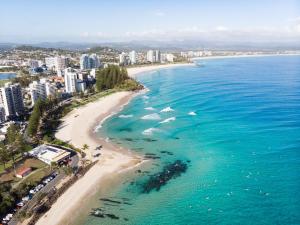 an aerial view of a beach and the ocean at Absolute Kirra by EcoTime in Gold Coast