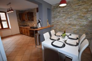 a dining room with a white table and chairs at au pied du Haut Koenigsbourg 1 in Saint-Hippolyte +7 photos