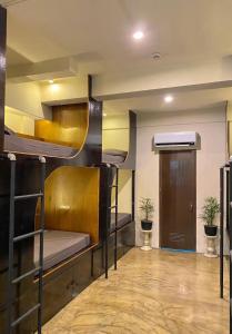 a room with bunk beds and a hallway at Mojo Hostel in Puerto Princesa City