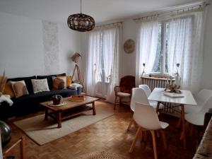 a living room with a couch and a table and chairs at Appartement Fritz Proche Gare SNCF de Tours, Bus et Taxi in Tours